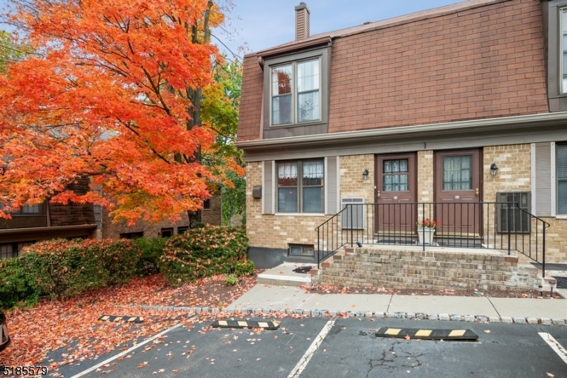 Spacious end unit in an ideal location! Bright and airy townhome offers three levels of living space with two bedrooms and two and a half bathrooms in the sought-after Inwood at Great Notch community. Enjoy carefree living in a park-like setting tucked into the woody foothills of lower Passaic County. Just twelve miles to the Lincoln Tunnel, this townhome is ideal for commuters, with a bus stop right around the corner and two train stations for the Midtown Direct to Manhattan, one at nearby Montclair State University and one in the center of town. On the main level, the foyer flows to a large, bright kitchen with ample counter and cabinet space and a pass-through to the dining area. The open layout continues to the living room with a corner wood-burning fireplace and sliding glass doors to a small patio and woodsy views of the grounds. The second floor includes the primary bedroom suite with large double closets and a full en suite bathroom, a second bedroom, and a full bathroom in the hallway (wood floors under carpeting) . The partially finished basement level offers a large recreation room that could be used as an office, a powder room, a walk-in closet, and a laundry area. This serene, pet friendly community offers tennis courts, a playground, a dog park, a swimming pool, and assigned and visitor parking, as well as proximity to stores, restaurants, parks, and quick access to major highways including Routes 46, 23, and 80.