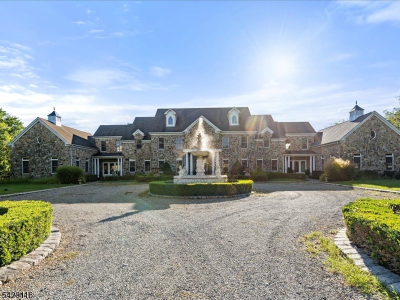 Custom built '02 on 35+ idyllic acs, in neighborhood cul-de-sac. this Estate Manor Home of Hand-hewn Cottage Stone, Handsome pillars & wrought Iron tracery is unrivaled. Upon entering the foyer, arched doorways framed by columns welcome you to vistas of rms, tall transom south facing windows and balconies embrace breathtaking distant views. Chef's kit has it ALL.2 story Cigar Rm w/FP and Gallery above, 4 FPs, front and rear staircase w/wrought iron baltustrades. Many custom built-ins thru-out. Private Guest/Au-Pair BR/Ba 1st fl.Flooring of diag. polished porcelain, Stone, and rich hardwoods of walnut and cherry. Cathedral Game/Play Rm. w/half bath. A 4 Room Master Wing w/Study,Sitting Rm, fr/rear balconies & exercise rm. Outdoor spectacular Caribbean Baha theme w FF Pool/Spa, 4 waterfalls, yr round Palm Trees.