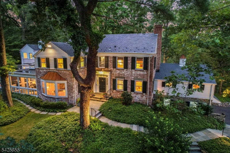 If you value privacy & the serenity of nature, combined w/the luxury of innovative contemporary design, this handsome & stately 6BR, 4.2 Bath, Center Hall Colonial is for you. Overlooking the So. Mountain Reservation from high above the neighboring homes, this one-of-a-kind residence combines the lifestyle of today, while blending the elegance of the past. Large 3 story addition w/2nd floor deck, connects all 3 levels from a staircase tower, designed by award-winning architect Shelton Mindel & Associates in Manhattan. Entertaining is a dream in this tastefully renovated & expanded home w/heated pool, separate spa area, electronic pool cover, bluestone patios, lighted fountain near firepit, upper deck, delightful screened porch off of the great room & living room, + a whole house Generac generator. Special features: handsome moldings, hardwood floors, 5 gas fireplaces, walls of windows, unique lighting & room for a 5th BR on the 2nd floor. There is a BR/Bath suite off of the kitchen, + a powder room near the library, could be a main level wine room. The yard offers the ideal 'staycation' vibe w/outdoor shower & changing room, the ground level bsmt has room for everyone w/billiards room, playroom, card room, a full bath & half bath, extra Refrig + plenty of storage. The property has beautiful, flowering trees, bushes, extensive outdoor lighting & mature landscaping, all on over.81 of an acre. This hidden & private gem at the end of a quiet cul-de-sac, awaits your visit.