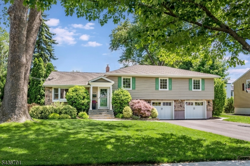 Welcome to the Glen Rock home you've been waiting for! This thoughtfully updated 4BR, 2.5BA expanded split-level offers a versatile floor plan ideal for modern living. The entry foyer leads to a bright living room with bay window and a formal dining room with elegant wainscoting. The heart of the home is the expansive chef's kitchen, complete with generous center island, double wall ovens, and pot filler. It overlooks the spectacular great room boasting a new modern fireplace, refinished hardwood floors, and built-in Sonos speakers. A few steps away, a delightful sunroom serves as a year-round retreat with cozy heated floors, cedar battenboard, and new sliders to the lush backyard. This level also includes a private den, ideal for a home office, a powder room, and laundry. The finished lower level offers bonus living space to fill so many needs. Upstairs, you will find four generous bedrooms, including a large primary ensuite. Both full bathrooms have been beautifully renovated with premium finishes and luxurious heated floors. An absolute standout is the oversized two-car garage, completely transformed with new high-end epoxy floors, a custom slat-wall organizing system, built-ins, and new doors. Too many updates to list! Turn-key and packed with premium updates, this exceptional home lets you immediately enjoy everything Glen Rock has to offer, including top-rated schools, an easy NYC commute, a vibrant downtown, and the beloved town pool, just in time for summer!