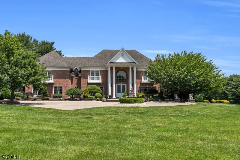 Welcome to this magnificent estate set on over 6 acres of meticulously landscaped grounds, offering the ultimate blend of sophistication, comfort, and resort-style amenities. This sprawling residence features 5 well-appointed bedrooms, 7 full and 2 half baths, including a luxurious first-floor primary suite with a spa-like bath perfectly designed for comfort and privacy. Step inside to soaring ceilings, rich hardwood floors, detailed architectural moldings, and elegant spaces ideal for both grand entertaining and everyday living. A stately first-floor office, expansive billiard room, and flowing open layout elevate the home's appeal. Estate boasts cabana house with pizza oven and full bathroom, along with a tennis court and volley ball court.