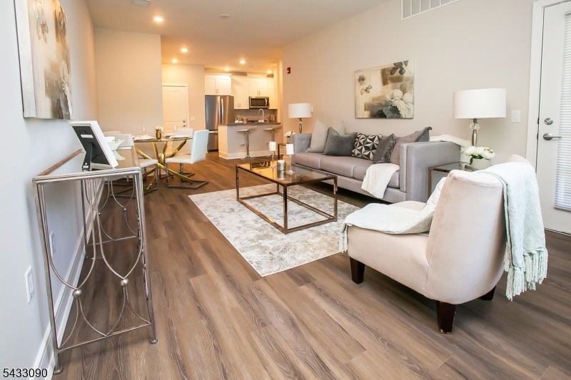 Welcome to Brookplace Luxury Rentals, a collection of 36 thoughtfully designed residences offering modern comfort and upscale living. This beautifully appointed second-floor 2-bedroom, 2-bathroom unit features a spacious open-concept layout enhanced by high-end finishes throughout.The contemporary kitchen is complete with sleek quartz countertops, stainless steel appliances, and seamless flow into the inviting living and dining area perfect for both everyday living and entertaining. Step outside to enjoy your own private balcony, creating an ideal extension of the living space.The primary suite offers a generous walk-in closet, plush carpeting, and a private full bath designed for comfort and convenience. Additional features include an in-unit washer and dryer, private garage parking, and a dedicated storage room. Residents also enjoy access to a beautifully maintained outdoor common area with BBQ grills, perfect for relaxing or gathering with guests.Ideally situated just minutes from shopping, dining, and everyday conveniences, Brookplace Luxury Rentals also offers exceptional accessibility for commuters, with close proximity to Routes 46, 80, and 280, providing an easy approximately 30-minute commute to New York City.