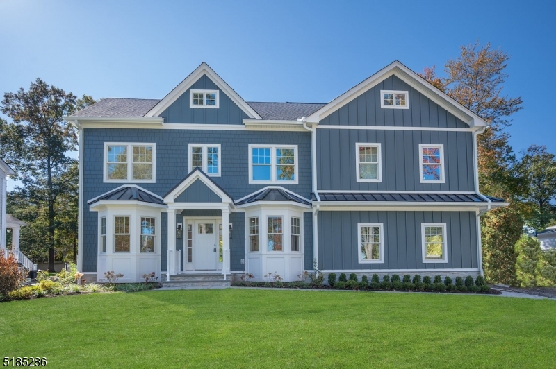 Upscale new construction with superior craftsmanship with over 6,000 sq ft of finished living space. This handsome home is set on a flat .36 AC lot that affords gorgeous views of Canoe Brook golf course. With 6 bedrooms including a bedroom on the 1st floor and lower level, a 3rd-floor bonus room with over 1,000 sq ft of finished space and multiple options for private office space, this home offers the ultimate flexible floor plan. The 1st and 2nd floors have 5" white oak floors and 9 ft ceilings. The fireside great room is open to the kitchen and has lofty 16 ft ceilings. The kitchen with white shaker cabinets, a custom curved Hoodsley wood hood, Calcutta Prado quartz counters and a contrasting center island includes a high-end appliance package (Viking 48" Range, 42" Jen-Air fridge, Sharp microwave drawer, and XO beverage fridge). The kitchen offers access to a walk-in pantry and a wet bar with a 46-bottle wine refrigerator. The primary suite is spacious and airy with 14 ft ceilings with custom arched millwork detailing, an oversized walk-in closet, an office that could also be converted to a second closet and the primary bath with his and hers sinks, soaking tub, walk-in shower and a separate room for the commode. With its 10 ft. ceilings, the lower level includes a large, open recreation space with storage closets, a gym, and a full bedroom and bath. This meticulously built home was designed by Thomas Baio, Architect with interior design choices by Karen B. Wolf Interiors.