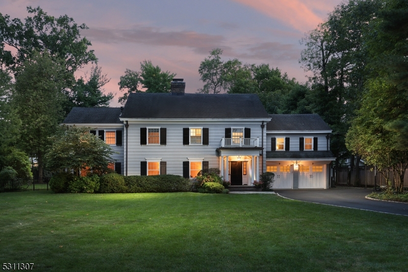 Exceptional 6 bedroom, 5.1 bath home in the heart of The Gardens.  First floor enjoys a foyer open to the formal living room with woodburning fireplace, dentil moldings and built-in shelving.  Adjacent is a handsome office with custom built-in cabinetry. The formal dining room with bay window overlooking the backyard and opens to the floor to ceiling sunroom. The kitchen is a chef's dream offering an expansive center island with leathered granite top, marble countertops, professional grade stainless steel appliances and a separate eating area.  The family room has a vaulted ceiling and gas fireplace flanked by built-in cabinetry.  A mudroom with built-in cubbies, laundry room, full bath and powder room complete the first level.  The second level is home to the primary suite with gas fireplace and private bath including dual sink vanity, jetted tub and oversized stall shower.  Five additional bedrooms and two hall baths finish the second level.  The lower level includes a rec room/media room and full bath.  Set on over a half acre of manicured grounds including an expansive blue stone patio with stone fireplace and outdoor kitchen. This home is conveniently located to schools, parks, and downtown Westfield for shopping, dining and NYC transportation.