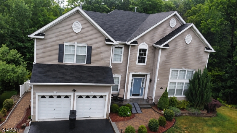 Well-maintained 4-bedroom, 2.5-bath home situated on a corner lot with peaceful wooded views. The home features a comfortable layout with an additional den that can be used as a home office, study, or flex space. The living room includes a fireplace, creating a warm gathering area during cooler months.A walkout basement provides valuable bonus space for storage, hobbies, a workshop, or future customization. Outside, the landscaped yard includes a fire pit area for relaxing or entertaining. A standby generator offers added convenience and peace of mind. The wooded backdrop provides a sense of privacy while still being conveniently located near local amenities.