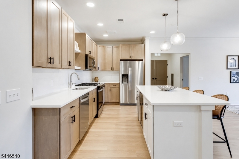 Luxury 2-bedroom, 2-bath condominium in Westfield's premier residential community. Built in 2024, this beautifully appointed home features an open-concept floor plan, designer kitchen with center island, quartz countertops, stainless steel appliances, wine refrigerator, spacious living and dining areas, in-unit laundry, walk-in closet, luxury vinyl flooring, central air, elevator access, and one assigned garage parking space. Conveniently located near downtown Westfield, shopping, dining, NJ Transit, and major highways.