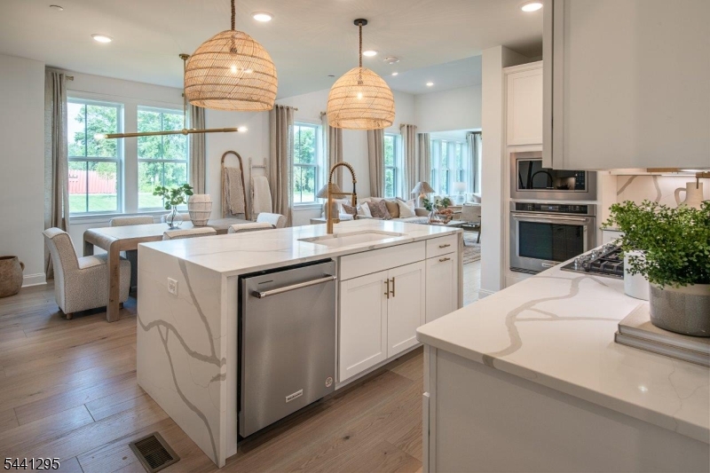 Located in the highly desirable borough of Far Hills, just minutes from the Far Hills train station and downtown Bernardsville, this beautifully appointed end unit Branton offers refined living in a premier setting. The home features a stunning kitchen with upgraded designer appliances and a large center island, seamlessly flowing into the open-concept dining area and great room. This inviting space is ideal for entertaining and is highlighted by a designer gas fireplace. The first-floor primary suite offers exceptional comfort with walk-in closet and a private en suite bath. Also on the main level is a private home office, providing an ideal space for working from home. The second floor includes two spacious bedrooms, each with its own walk-in closet and en suite bath, along with a generous loft area perfect for additional living or relaxation space. Anticipated delivery is December 2026. This is an age-restricted community. Still time to select custom design options. Photos are of a similar home.