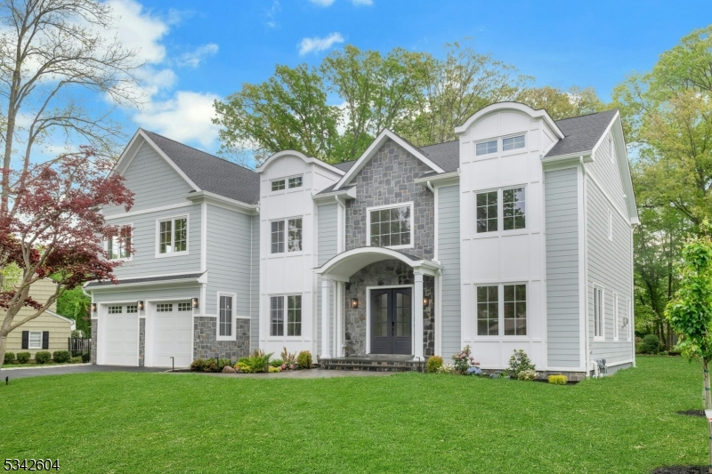 This stunning 7-bedroom, 8.1-bathroom colonial new construction offers over 7,700 square feet of meticulously finished living space across 4 finished levels. This home boasts an expansive open floor plan, white oak hardwood flooring and dramatic white oak staircase. Soaring 10' ceilings on the main level and 9' on the second floor and fully finished basement. Abundant natural light floods the interiors through large European tilt-and-turn windows. The heart of the home is a true gourmet kitchen featuring ceiling-height custom cabinetry, a massive center island, top-of-the-line Viking appliances, and a large furnished hidden pantry. Every bedroom is an ensuite with its own private bathroom and walk-in closet. The luxurious primary suite is a standout, highlighted by a vaulted ceiling in the bedroom and a spa-like master bathroom with heated floors and Grohe plumbing fixtures. Additional premium features include three high-efficiency HVAC units with five-zone Nest thermostats, a dedicated EV charger, and pre-wiring for a 5-zone audio system, security system, and WiFi. Outside, the residence is wrapped in premium HardiPlank siding and shingles, custom Azek trim, and striking stone entry. The grounds are enhanced by a large patio, meticulous landscaping, multi zone sprinkler system and architectural outdoor lighting that beautifully illuminates the home's elegant facade after dark.