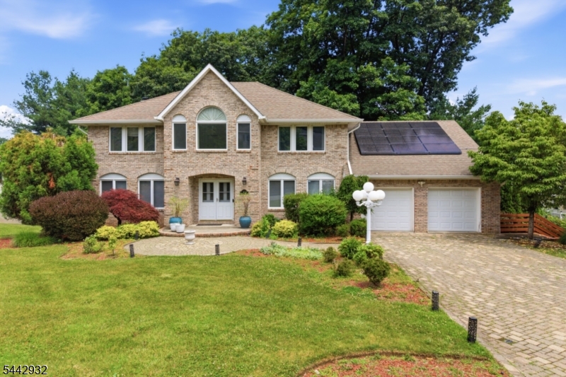 Welcome to this lovely colonial-style single-family home, offering exceptional space, comfort, and convenience in one of Morris Plains' most highly desirable neighborhoods   Powder Mill. Featuring over 4,000 sq ft of total living space, this residence provides an ideal layout for modern living with plenty of room to grow. The home includes a finished, walkout basement with a full kitchen, perfect for a recreation space or extended living area. Notable features include solar panels (w/ battery power back-up), central vacuum, ADT security system, Sub-Zero refrigerator and underground sprinklers, all contributing to efficiency and everyday ease. Outside, the property offers a lengthy driveway accommodating multiple cars, along with a backyard that boasts a large deck and storage shed, delivering both practicality and ample outdoor enjoyment. Located just minutes from Route 10, residents enjoy quick access to restaurants, grocery stores, shops, essential conveniences, and a highly rated school system (Parsippany-Troy Hills Township School District). A standout opportunity in Morris Plains, combining classic colonial charm with valuable modern amenities.