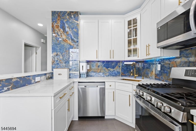 Welcome to this beautifully renovated 3-bedroom, 1-bath first-floor apartment offering the perfect blend of style, comfort, and convenience. Thoughtfully updated throughout, this bright apartment features abundant natural light, a stunning high-end modern kitchen with ample cabinetry and quartz countertops, an updated bathroom, and the convenience of an on premises washer and dryer. Enjoy the rare bonus of exclusive access to a private backyard, ideal for relaxing, entertaining, or enjoying summer evenings outdoors. Located in the heart of Kearny, you'll be just minutes from shopping, restaurants, parks, schools, and major highways, with easy access to NJ Transit for a convenient commute to New York City. Everyday essentials are all within close reach, making this an exceptional location for commuters. This move-in-ready home offers the space, updates, and location today's renters are looking for. Schedule your private showing today and discover why this beautiful apartment feels like home from the moment you arrive.
