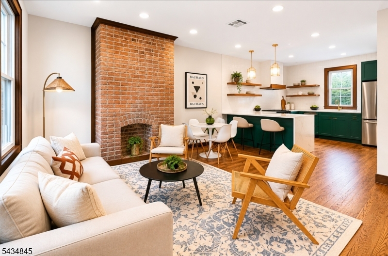Beautifully gut renovated two-family home located less than one mile from the Journal Square PATH, offering convenient access to NYC and nearby transportation, shopping, and dining. The property features a total of 3 bedrooms, 4 full bathrooms, and 2 kitchens. The owner's duplex spans two floors, blending classic charm with modern custom design, and includes washer/dryer hookups. The legal one-bedroom apartment offers a kitchen, full bathroom, walk-out to back yard with laundry hookups. This versatile two-family layout provides flexible living arrangements with income-generating potential. Brand-new siding and turn-key condition complete this exceptional offering.