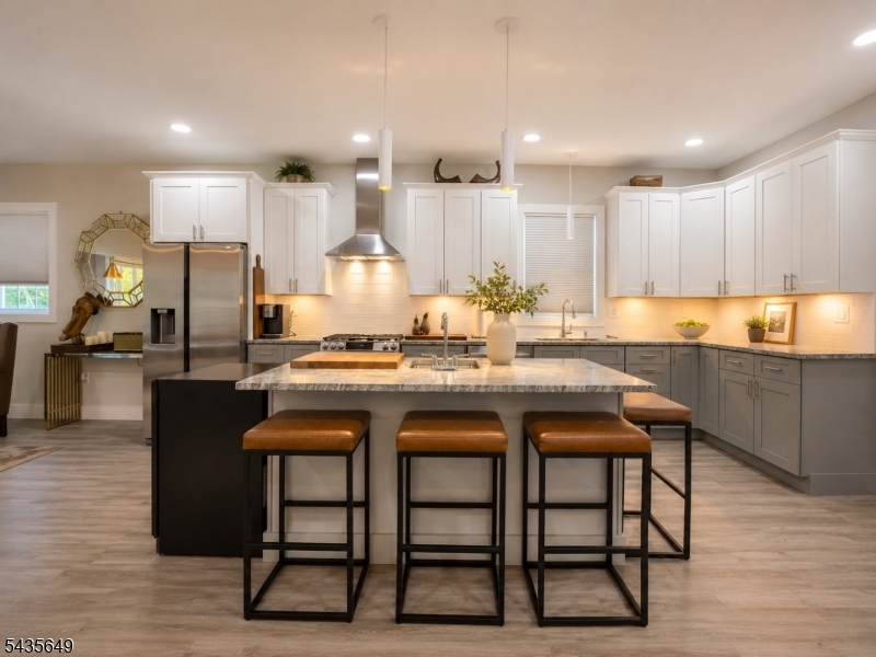 Welcome to this exceptional 2023 custom-built home offering modern design, comfort & privacy just moments from Lake Hopatcong. Situated on a .34-acre wooded lot at the end of a secluded street, this 4-bedroom, 2.5-bath residence features over 2,300 sq ft of thoughtfully designed living space. The open-concept main level showcases high ceilings, recessed lighting, a cozy gas fireplace & a beautifully appointed kitchen featuring leathered granite countertops, a large center island with prep sink, microwave drawer, stainless steel exhaust hood & abundant workspace for cooking & entertaining. The kitchen flows seamlessly into the dining area with access to a private rear deck overlooking a peaceful wooded backdrop. Upstairs, you'll find 4 generously sized bedrooms, including a spacious primary suite with vaulted ceilings, a private bath & walk-in closet. Additional bedrooms offer ample closet space, while a convenient second-floor laundry room adds everyday functionality. Additional highlights include dual-zone heating & cooling, an unfinished walkout basement with plumbing rough-ins for a future bathroom, an attached garage & modern systems throughout. Conveniently located near shopping, dining, major commuter routes & New Jersey's largest lake, residents can enjoy boating, fishing, kayaking, watersports & optional membership opportunities at nearby Crescent Cove Beach Club. A rare opportunity to own newer construction in one of Hopatcong's most desirable residential settings.