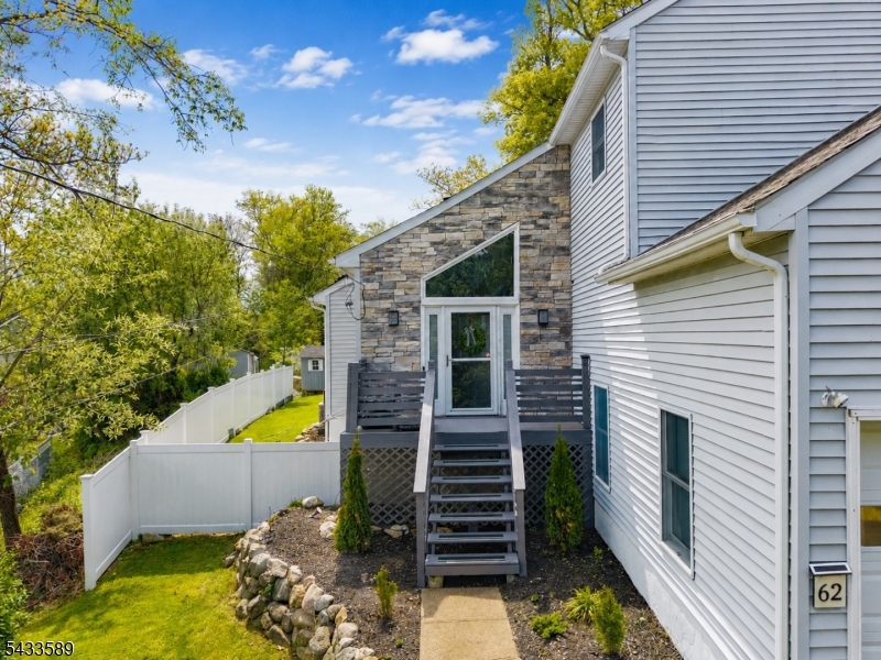 Welcome to this beautifully updated turn-key Colonial offering 3 bedrooms, 2.5 baths, and a perfect blend of modern upgrades and timeless charm. From the moment you step inside, you'll appreciate the fresh paint throughout, updated trim work, and new tile foyer that create a bright and inviting first impression.The renovated kitchen features white shaker cabinetry, stylish tile backsplash, and an open flow into the dining and living spaces   ideal for both everyday living and entertaining. The spacious living room showcases soaring ceilings, abundant natural light, hardwood flooring, and a cozy fireplace that adds warmth and character.Upstairs, new engineered hardwood flooring enhances the home's clean, modern feel, while the primary suite includes a custom built-in feature for added style and functionality. Two bathrooms have been tastefully updated, offering a fresh and contemporary look. Additional recent improvements include updated electrical throughout, newly installed first-floor heat baseboards, a newly installed water treatment/softener system, and a new furnace installed in 2024 complete with a 10-year warranty for peace of mind. Outside, enjoy refreshed landscaping and repaired decking perfect for relaxing or entertaining outdoors.Situated in a desirable setting near beautiful lake scenery and surrounded by mature trees, this meticulously maintained home is truly move-in ready and offers the perfect combination of comfort, style. Home is powered by solar.