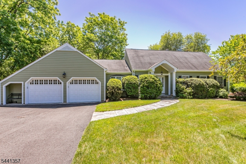 There is a serenity to this home that is difficult to define but impossible to miss. Natural light pours through three skylights in the vaulted ceilings, gathering spaces flow together in an open plan, and the backyard drifts gently toward the Millstone River, creating a setting that is both inspiring and deeply peaceful. This home is filled with thoughtful details you just won't find in other homes. Rather than facing the front door, the staircase turns inward, drawing the eye naturally upward. Along a second-floor gallery, built-in bookcases create a quiet sense of purpose, while a balcony offers an elevated perch for birdwatching and nature sightings. The primary suite is set apart from the other bedrooms here and features a walk-in cedar closet and private bathroom. Two additional bedrooms, a full bath, and a powder room are all on the main level. Living and dining areas look upon a fireplace surrounded by shelving. The kitchen is spacious, modern, and designed for the everyday, with dual wall ovens, a gas cooktop, Bosch dishwasher, and laundry discreetly tucked within a closet. Just beyond, a heated porch extends the living space year-round, opening to the deck and the landscape beyond. Although set high and dry above the river, the property finds its natural conclusion at the river's edge, making it conducive to kayaks and canoes