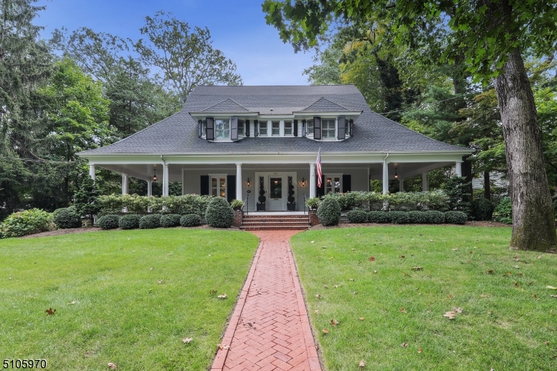 This turn of the century center hall colonial is a true one of a kind gem. Impeccably renovated to today's style and taste. This home boasts an elegant wrap around porch that is perfect for entertaining.   Close to town, train, schools. Privacy & Location. Grand scale rooms, high ceilings, architectural detail. New Design includes incredible  custom kitchen and family room, newly renovated lower level with recreation room, wine cellar, back staircase, 2 laundries, banquet sized dining room, 4 fireplaces.  6 bedrooms 5 full baths.  Bonus third floor gym with bedroom and additional bath. Oversized detached garage with loft space.  Great potential!  This very special home is not too be missed.