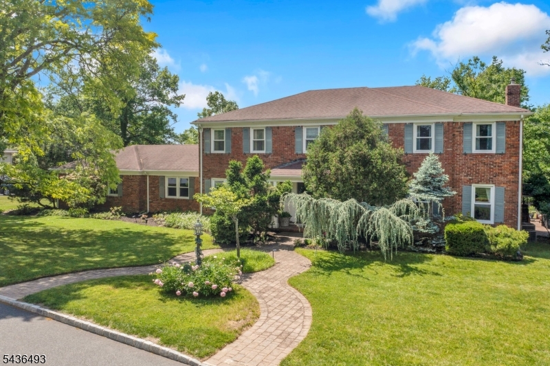 Nestled in one of West Orange's most sought-after neighborhoods, this elegant Center Hall Colonial offers the perfect blend of space, comfort, and opportunity. The main level features a welcoming family room with a cozy fireplace, formal living and dining rooms, and a spacious eat-in kitchen with abundant cabinetry and endless potential. A first-floor bedroom and full bath provide flexibility for guests, a home office, or private workspace.Upstairs, the oversized primary suite serves as a private retreat with a large walk-in closet and en-suite bath. Additional generously sized bedrooms offer comfort and versatility for a variety of needs.The finished basement expands the living space with a large recreation room, custom working bar, flexible bonus areas ideal for a gym, office, or playroom, and two dedicated storage rooms.Step outside to a beautifully landscaped backyard featuring a patio, mature greenery, and colorful gardens, creating the perfect setting for relaxation or entertaining. An attached two-car garage and oversized driveway provide ample parking.Located in a highly desirable section of West Orange, close to parks, shopping, dining, and major transportation routes, this home offers exceptional space, a flexible floor plan, and endless possibilities to make it your own. A rare opportunity to own a classic Center Hall Colonial in one of the township's most coveted neighborhoods.