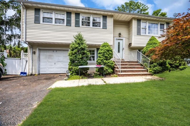 Great opportunity to make this home your own! This spacious home offers tremendous potential and is ready for your personal touch. Step up into a generously sized family room, perfect for relaxing or entertaining. The home features large bedrooms, including a primary suite with a full private bath. The expansive kitchen provides plenty of space for cooking and gathering, making it ideal for a chef. Large windows throughout the home fill the interior with abundant natural light, creating a bright and welcoming atmosphere. On the ground level, you'll find a powder room, a spacious living area with access to the patio and large open backyard, a guest bedroom, a sizable laundry room, and convenient entry to the attached garage. With great bones, ample living space, and endless possibilities, this home is a fantastic opportunity for buyers looking to add their own style and updates. Water Heater 2022, Roof 2022, A/C 2021.