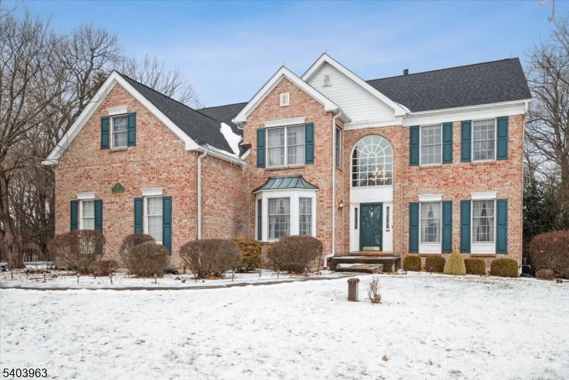 Experience refined living in this elegant Toll Brothers Colonial, ideally nestled on a quiet cul-de-sac with scenic mountaintop surroundings that provide privacy and a peaceful sense of retreat. The stately brick-front exterior creates a striking first impression and introduces a thoughtfully designed, highly functional layout. Step into the grand 2-story foyer, opening to a main level with 9-foot ceilings, hardwood floors, and abundant natural light. A private home office with French doors, a formal dining room and the inviting family room that is the heart of the home, featuring a soaring cathedral ceiling with skylights, a dramatic floor-to-ceiling brick fireplace, and a convenient rear staircase. The eat-in kitchen blends style and function with granite countertops, SS appliances, a center island, and direct access to a spacious Trex deck perfect for indoor-outdoor living. Upstairs, the expansive primary suite offers a serene retreat with a sitting area, oversized WIC with makeup station, and a spa-like bath complete w/jetted soaking tub, stall shower, and fireplace. Three additional bedrooms and a full bath complete this level. The walkout basement features high ceilings and endless potential to create your own oasis, with direct outdoor access. Outside, enjoy a private backyard escape with a heated inground pool and outdoor shower, ideal for summer entertaining or quiet evenings. A beautiful blend of comfort, functionality, and elegance in a truly picturesque setting.