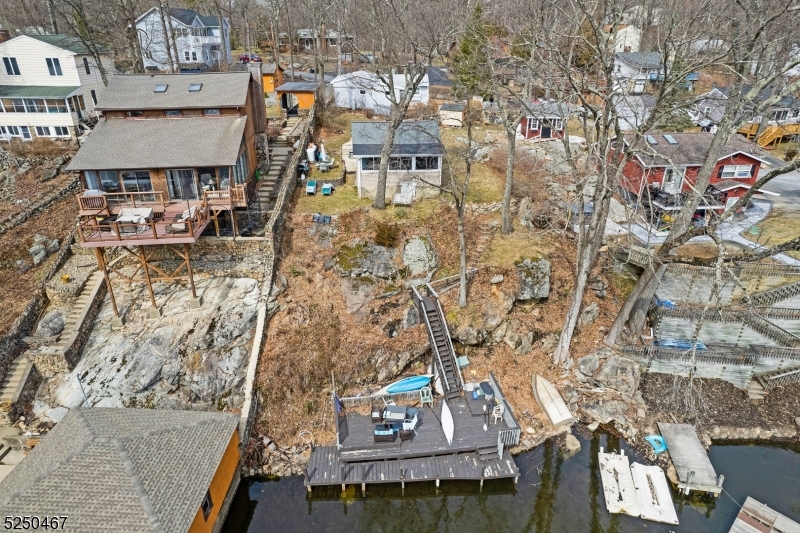 Calling all Investors & Lakelovers!!! Opportunity to own two single family properties in the Byram Cove section of Lake Hopatcong. One property - 329 Squaw (Block 50410 and lot 2) is lakefront and the other is adjacent to the other property. Lakefront house is 2 bedroom, 1 bathroom, galley kitchen, living room/dining room with amazing lake views. Walk down the steps to the dock. Two parking spots deed to home by the street. Second house - 331 Squaw (Block 50410 and lot 3 ) is 3 bedrooms, 1 bathroom with a large living room and eat in kitchen. House has 2 parking spots on crushed stone driveway. Properties have separate septic and shared well. Properties MUST BE SOLD TOGETHER.  Investors/Cash Buyers preferred. Properties have opportunity for membership at Byram Bay Community Club. Homes are being sold "AS IS" where is.