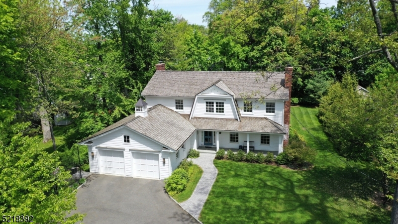 When a designer's purist vision meets a builder's immaculate craftsmanship, a masterpiece is created. This total-home reconstruction exudes an attention to detail in every inch. First impressions are created with the cedar roof, true divided-light windows, 6-panel glass front door, cupola, bluestone front porch; & this is only the exterior!Upon entering the generous foyer, a thoughtful flow carries through the main level. A large LR features a wood-burning fireplace that flows seamlessly to the DR.The white kitchen has a lrg center island, farmhouse sink, designer lighting & lots of windows.New updates include; redesigned floorplan, Andersen windows, HVAC, cedar roofing, cement composite siding, garage rebuild, & electric panel.The family room is adjacent to the kitchen & perfect for gatherings or cozy evenings. Gas FP with shiplap surround, custom built-in bookshelves, French doors leading to the amazing covered porch accented with a bluestone floor & white railing.The mudroom is unique in its design & function w/multiple storage options for today's busy lifestyles. A full basement has a generous rec room, recessed lighting, workspace & storage area.The 2nd floor has been reconfigured and thoughtful in its design. 4 BRs and 3 Full BA round it out. The primary suite has 2 lrg custom closets and spa-like bathroom.All of this nestled on 1 of Chatham Boro's most sought-after streets. A short walk to all of the top-rated schools, NY Direct train line, and downtown.