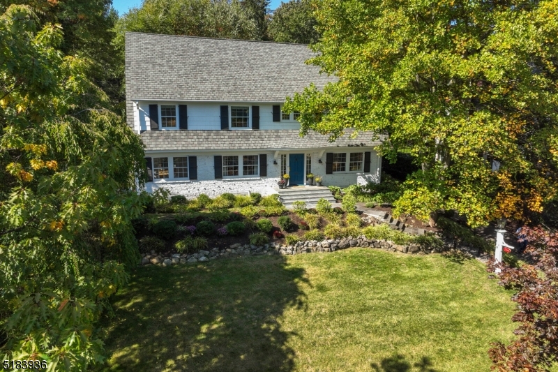 Located in the highly-coveted Estate Section and perched high on South Mountain Ave facing NYC, this sun-drenched, classic Center Hall Colonial won't disappoint!  A gracious entry foyer is flanked by a beautifully scaled living room with fireplace & dining room.  A true chef's kitchen with a large center island, quartz counters/backsplash, Wolf range, Sub Zero refrigerator & a breakfast area with fireplace where everyone can gather for the holidays. A sun-filled family room, home office, powder room, and mudroom complete the 1st floor. Upstairs offers an exquisite primary bedroom with spa-like ensuite bath, 3 additional corner bedrooms, 2 full baths & hall laundry.  Third floor has 2 more ample bedrooms, an office or additional bedroom if needed, and a hall bath. Lower level features a finished rec room, temperature controlled wine cellar, laundry room, and powder room. The outdoor terraced bluestone patio with an inground pool and waterfall makes for amazing entertaining!