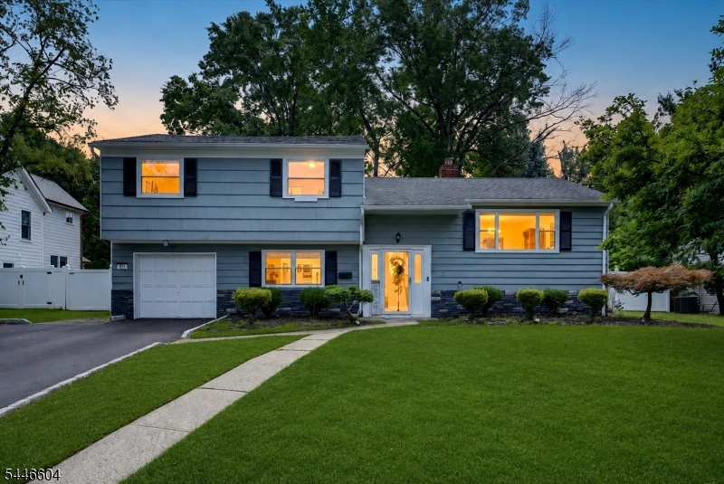 A bright, airy split level on a quiet no pass through street in Westfield sitting on over half an acre of property. In this town, that alone is something special. Step into the foyer and head up to the main level where vaulted ceilings and sunlight take over. The open floor plan flows naturally from the living room into the dining room and into the updated kitchen with a breakfast bar that is basically designed for gathering. The kind of layout where the host never feels left out of the conversation. Upstairs three spacious bedrooms including a primary with its own full bath and a main bath rounding out the level. Calm, comfortable, and plenty of room for everyone. Head down to the ground level and you have a spacious family room that can flex as a home office, playroom, or hangout space, plus a powder room and direct access to the backyard. And that backyard. Over half an acre with mature trees, a patio, and a pool. Epic games of wiffle ball. Volleyball in the pool. Summer BBQs that stretch into the evening. This is the backyard that becomes the reason everyone comes to your house. Newer central air and furnace. Unfinished basement ready for your vision. This is one worth seeing!