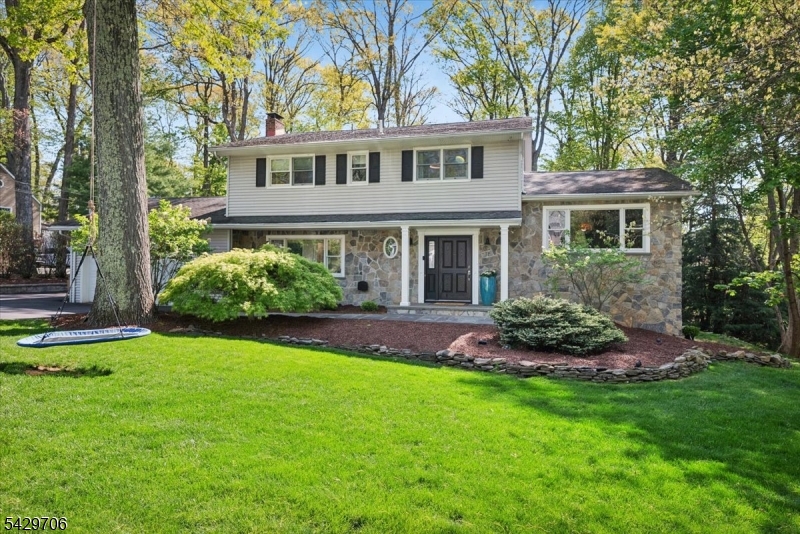 Renovated, turnkey, and beautifully designed for today's lifestyle, this Colonial on Randolph's desirable east end offers city utilities, top-rated Randolph schools, and a convenient location near parks, shopping, dining, and commuter routes. A bluestone walkway, stone-accented exterior, newer driveway, and irrigation system create impressive curb appeal from the moment you arrive. Inside, the bright open main level was thoughtfully renovated in 2023 for modern living. Wide-plank hardwood floors, moldings, and natural light connect the spacious living room with custom built-ins and a floor-to-ceiling stone fireplace, open dining area with backyard views, and redesigned kitchen with 2 tone custom cabinetry, granite counters, SS appliances, and expanded windows. The flow continues into inviting gathering spaces, including a stylish family room, with wall paneling and built-in Bose speakers. A powder room, laundry, pantry with extensive shelving, smart features, and Generator and EV charger hookups add everyday convenience. Upstairs offers a serene primary suite and renovated bath, 3 additional beds, including a guest suite, and a  hall bath. The finished lower level extends the home with high ceilings, recreation space, and a dedicated office. Outdoors, enjoy a freshly stained deck, hot tub , storage shed, play set, trampoline, and swings. With a new 2026 roof, newer mechanicals, windows+doors, this home blends comfort, style, and value in one of Randolph's prefered locations.