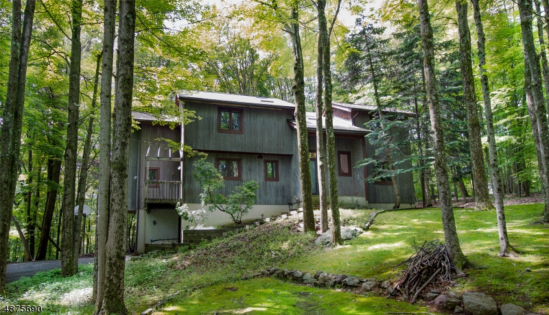 Access to the highly desirable Mountain Lakes High School District, this home is set in a wooded country setting with beautiful views from this secluded contemporary tongue and groove cedar sided, 3 bedroom, 2 1/2  bath home on over 2.5 acres in Boonton Twp.  Great walking trails, hardwood floors, updated kitchen and plenty of storage. Attached two-three car garage, storage/work room on lower level. First floor laundry and bonus room that can be used as an office or playroom. Country living with all the city amenities!