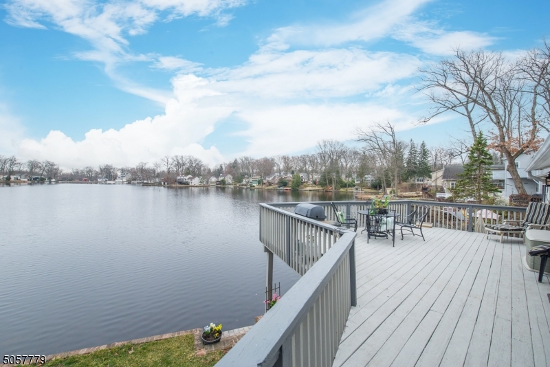 Start enjoying Lakefront living in Rainbow Lakes! Walk right in & instantly be impressed with the lake views! Located on the  main  lake this 3BR, 2BTH home offers views from every corner. EiK w/high, vaulted ceiling. LR features a WB stone fireplace, tons of windows & a slider to the oversized deck. A huge bath & laundry completes the 1st level. The 2nd level offers 3 bdrms & an updated full bath. Bonus walk out, bsmt has a ton of potential! Lots of room to finish w/access to lower deck & lake plus still provides storage space. Additional features include central air, gas heat, upgraded electric, 2 car garage & off street parking. New roof & skylights! Freshly painted inside & out w/new landscaping & exterior lighting. Be a part of this wonderful community with so many recreational activities to enjoy!