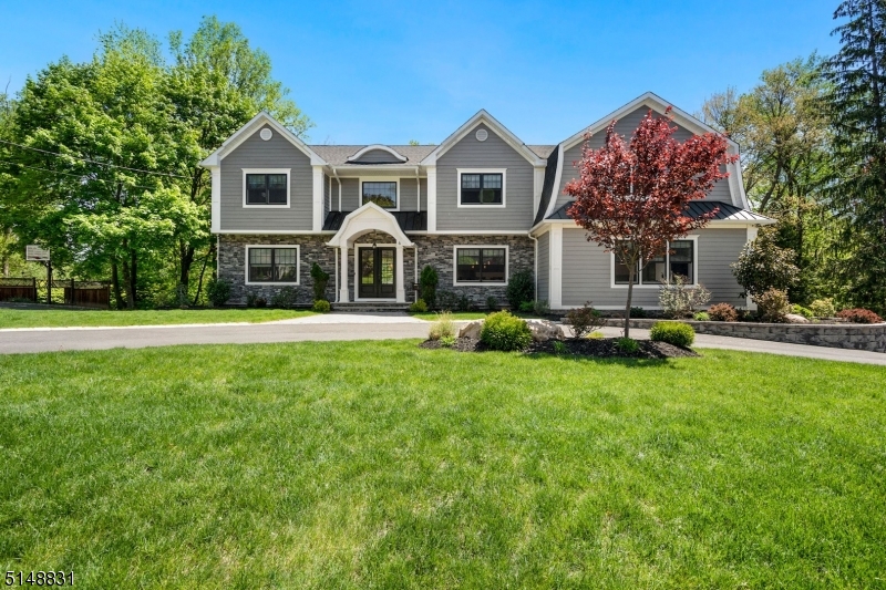 Stunning custom colonial home featuring the finest of finishes and modern amenities. This expansive home boasts 5 beds w/office & 5.5 baths which brings modern luxury, classic details, high-end craftsmanship and bright open floor plan. First floor offers an impressive foyer, soaring ceilings, gleaming wood floors ,magnificent moldings, custom built-ins, formal living & dining, inviting family room w/gas fireplace. Gourmet chef's kitchen with custom white cabinets, quartz counter, eat-in-kitchen, Wolf/Sub Zero stainless-steel appliances and center island. 1st floor en-suite, dedicated office and powder room completes this level. 2nd-floor features 4 bedrooms and a large laundry room. Spectacular primary bedroom designed w/tray ceiling, 2 walk-in closets & elegant spa bathroom w/soaking tub & double vanities. Finished walkout lower level is equipped w/huge recreation room, space for home gym, wet bar w/sink, lots of storage & full bath. This house offers central vacuum system/home speakers//wired Internet & cable /sprinklers. Exquisite outdoor space with expansive deck, gas line for BBQ and lush landscaping. Incredibly special and uniquely built home with no expense spared. This home is an entertainers dream and not to be missed!