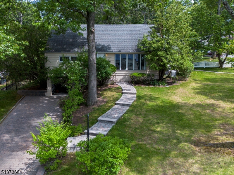 Welcome to 18 Aspen Road, a charming 4-bedroom, 2-bath Colonial ideally situated on an expansive corner lot in the Oaks neighborhood, one of West Orange's most convenient and desirable locations. Nestled in a quiet neighborhood, but close to all the action, this well-maintained home offers spacious living areas filled with natural light, creating a warm and inviting atmosphere throughout. The versatile floor plan includes a bright sunroom, perfect for relaxing, working from home, or enjoying your morning coffee, with walk-out access to a large patio that is perfect for entertaining.  Generous room sizes and flexible living spaces offer endless possibilities for customization, allowing you to make this home truly your own.  The home features ample parking, a one car garage, and a finished basement providing additional living and recreation space.  The home features central air heating and cooling with additional heat pumps for your comfort, and a backup generator for added peace of mind.  Located just moments from shopping, dining, and transportation options to New York City, this property offers the perfect balance of suburban comfort and commuter convenience. Outdoor enthusiasts will appreciate its proximity to South Mountain Reservation and Turtle Back Zoo, providing year-round opportunities for recreation and entertainment.