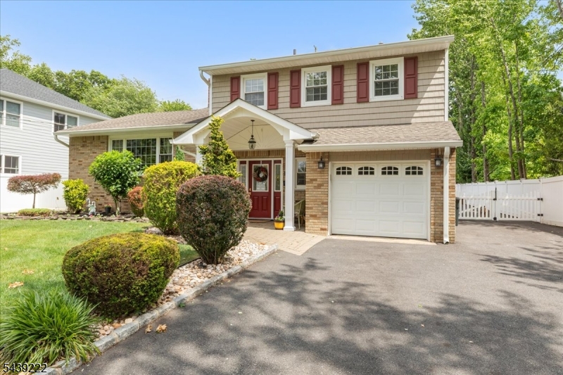 Welcome home to one of the best split-levels in Cranford! This property offers the perfect blend of comfort and overall space. Recently refinished hardwood floors and fresh paint throughout create a bright, move-in-ready interior, while the cozy wood-burning fireplace provides the perfect gathering space. A standout feature of the home is the rear addition, creating a large kitchen and dining area that serves as the heart of the home. Designed for today's lifestyle, the home features a functional layout with the convenience of second-floor laundry. Step outside to your private backyard retreat, complete with a large yard, spacious deck, and above-ground pool ideal for entertaining, relaxing, and enjoying summer days at home. A rare highlight of this property is the incredible garage and parking capacity. In addition to the attached one-car garage, you'll find a detached oversized two-car garage with heat and loft storage, perfect for car enthusiasts, contractors, hobbyists, or anyone needing extra workspace and storage. The expansive driveway accommodates 10+ vehicles, a feature rarely found in today's market. Combining move-in-ready condition, versatile living space, and exceptional outdoor and garage amenities, this home offers a unique opportunity to enjoy both convenience and lifestyle in one remarkable property.