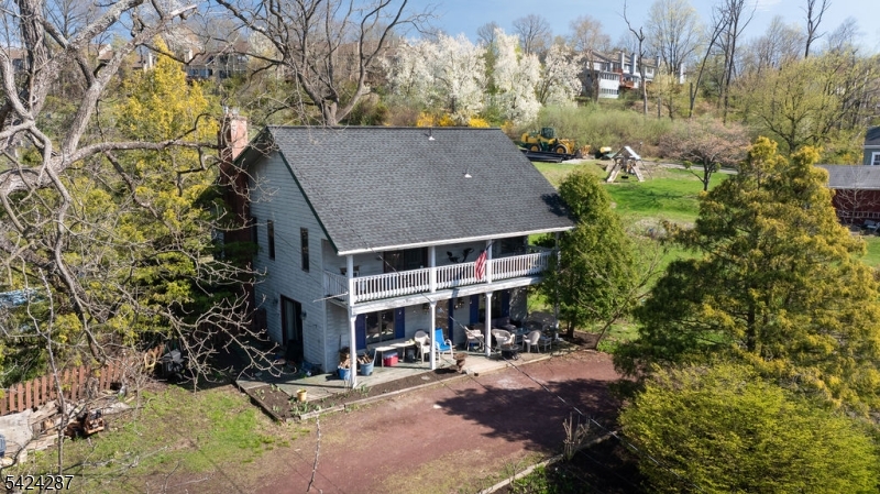 Situated on a generous 0.36-acre lot in the heart of Lambertville, 102 South Franklin Street presents an exciting opportunity to transform a home full of character into something truly special. This 2-bedroom, 2 full bath property offers a flexible layout and inviting spaces, ideal for those looking to add modern updates and personal style. The first floor features a comfortable family room, a bedroom, and a charming covered front porch perfect for relaxing and enjoying the surroundings. The second level offers a cozy primary bedroom with dual closets, an attached full bath, and access to a private balcony. Also located upstairs are the kitchen, living room, and dining room, with a rear porch just off the dining area, creating an easy flow for everyday living or entertaining. Outside, the expansive lot provides ample space and potential. The backyard includes an in-ground pool ready for a new liner and a fenced yard in need of replacement, offering the chance to create a customized outdoor retreat. A unique horseshoe driveway accommodates up to 10 vehicles, adding exceptional convenience. This home is truly a diamond in the rough, offering tremendous upside for those with vision. Ideally located near local dining, shopping, and popular events like Shad Fest, this property combines location, space, and endless potential. Seller is motivated and open to reasonable offers.