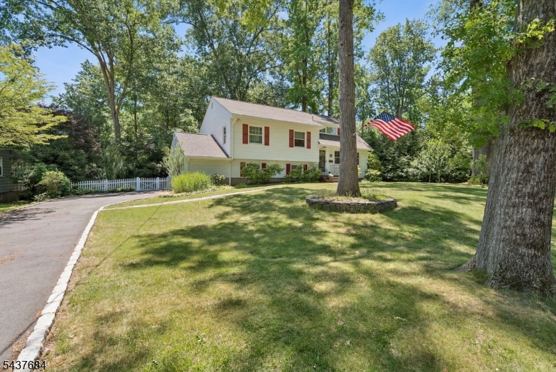 Nestled on a prime cul-de-sac location in desirable Packanack Lake, this spacious 4 bedroom, 2.5 bath split-level home offers a wonderful blend of comfort, functionality, and opportunity. The heart of the home is the newly renovated kitchen featuring white shaker cabinetry, granite countertops, stainless steel appliances, and an open flow to the dining room and formal living room, creating an ideal layout for everyday living and entertaining. The second level offers three generously sized bedrooms and a beautifully renovated full bath, with hardwood flooring waiting to be uncovered beneath the carpeting. Privately situated on the third level, the primary suite features its own en-suite bath and a versatile bonus room perfect for a home office, sitting room, or future walk-in closet. The ground level includes a spacious family room/rec room ready for your personal touch, a powder room, garage access, and a convenient outside entrance. Just off the kitchen is a charming new three-season room that overlooks the sprawling yard, just shy of a half-acre, offering endless possibilities for outdoor entertaining, recreation, gardening, or creating your dream backyard oasis. Enjoy all the amenities that Packanack offers including beaches, boating, park, community clubs and activities. Close to NYC transportation. Highly rated schools.