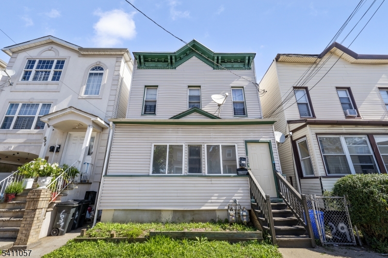 Don't miss this fully renovated two-family home in the heart of Elizabeth. This is an exceptional opportunity for investors and owner-occupants alike! Updated in 2025, each unit offers two bedrooms, a spacious living area, an eat-in kitchen, and a beautifully designed full bathroom. Both units feature luxury vinyl plank flooring, dark cabinetry with quartz countertops, herringbone tile backsplashes, stainless steel gas ranges, and refrigerators. The spa-inspired bathrooms impress with floor-to-ceiling gray tile, black-framed glass shower enclosures, rain head fixtures, and gold-accented mirrors. Each unit operates independently with separate gas heating systems, recessed lighting, and black ceiling fans throughout. On-street parking available. Conveniently sandwiched between Rt 9 and the NJ Turnpike, and a half mile from public bus transportation, this turnkey, move-in ready property is a rare find in a great location.
