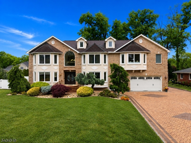 This exceptional custom brick colonial was thoughtfully built showcasing superior craftsmanship and quality finishes throughout. A stunning paver triple-wide driveway, marble railings, and impressive curb appeal welcome you into a grand two-story foyer featuring marble flooring and a breathtaking hand-painted ceiling mural. The gourmet chef's kitchen offers rich cabinetry, granite countertops and backsplash, SS appliances, skylights, soaring ceilings, and an oversized center island.The sun-filled living room features oversized windows, hardwood floors with decorative inlays, recessed lighting, and a gas fireplace, while a second gas fireplace anchors the family room. Detailed crown molding, custom trim work, and quality materials throughout the home.The dramatic open staircase with wrought iron railings leads to spacious bedrooms with abundant closets. The luxurious primary suite boasts soaring ceilings, oversized windows, hardwood floors, two enormous closets, a gas fireplace and a private balcony. The spa-inspired en suite bath features double sinks, skylights, and a soaking tub.Additional highlights include multiple full bathrooms, surround sound, recessed lighting, a finished basement with recreation room, gym, office, and bath, plus a fully functional shed. Located in a highly desirable neighborhood close to schools, parks, shopping, and major conveniences, this meticulously maintained home blends timeless elegance, comfort, and exceptional quality throughout.