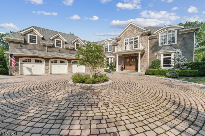Resort living in the heart of Short Hills. This stone and shingle 7 bedroom colonial offers the best of indoor/outdoor living. The 2 story entryway is flanked by a paneled library.The spacious gourmet kitchen with 2 islands is open to the large family room with coffered ceilings and fireplace. French doors open to the recently renovated yard with pool, patio, outdoor kitchen with bar, gas grill, granite countertops, fridge, hot tub and two outdoor Sunbrite tvs and pool bathroom. There is a first floor bedroom with ensuite bath. The second floor has five generous bedrooms including a large master suite with his and her walk in closets and sitting area.  The lower level has a wine room, an additional bedroom and baths with entertainment options for all in the home theater and large rec room. The whole house generator is an added bonus.