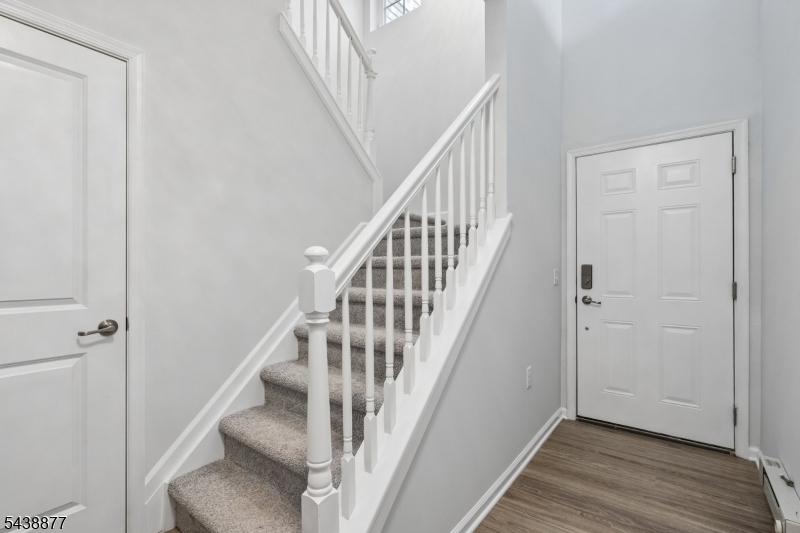 Welcome to one of Coventry Park's most beautiful homes! This meticulously maintained 3-bedroom, 2.5-bath townhome has been thoughtfully renovated from top to bottom, allowing its next resident to simply unpack and enjoy. The main level features high-end light laminate flooring, crown molding, and abundant natural light. The stunning kitchen, renovated in 2024, showcases white cabinetry, quartz countertops, stainless steel appliances, and a breakfast bar that opens to the living and dining areas, ideal for everyday living and entertaining. Upstairs, the primary suite offers a walk-in closet and a remodeled ensuite bath with a double vanity, quartz countertops, an updated mirror, and a large walk-in shower. The updated hall bath offers a double vanity with quartz countertops and a separate shower and toilet area. A second-floor laundry area includes a large front-loading washer and matching dryer, plus overhead storage cabinetry. All bedrooms and the hallway feature upgraded plush carpeting. Additional improvements include a newer hot water heater, water softener system, and new light fixtures, including a few Wi-Fi-enabled fixtures. The built-in one-car garage features synthetic tile flooring and ceiling storage racks, while the private driveway accommodates a second vehicle. Conveniently located minutes from major highways, NYC transportation, and shopping, this exceptional rental offers the perfect combination of style, comfort, and convenience.