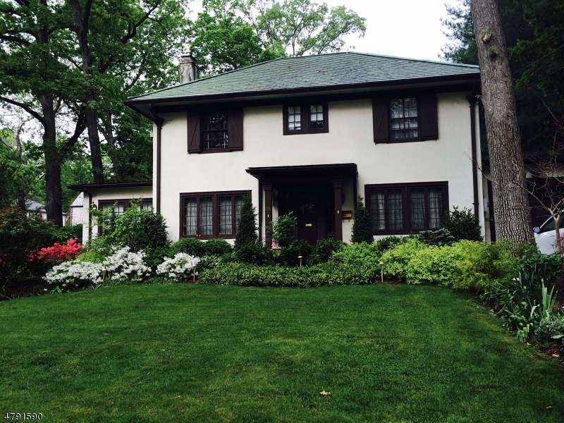 Located near sought after Ridge School w/NYC corner bus stop & easy walk to train & downtown, this 4,000+ sq ft value-priced home offers traditional charm & spaciousness for both everyday living & entertaining.  Wood-beamed LR w/stone FPL opens to office/sunroom  & has French doors to family room.  Enter the FDR leading to butler's pantry & spacious kitchen w/eating area & pantry.  FB w/stall shower on 1st fl.   FR & kitchen both open to skylight-lit unique multipurpose room w/stone wall waterfall, 2nd FPL & glass block windows leading to outdoor patio & backyard.  Upstairs is MBR w/WIC, bath w/double sink vanity & access to rooftop deck.  Down the hall are 2 spacious bedrooms w/full bath & stairs to 3rd floor additional BR w/sitting area & storage.  Finished basement w/wet bar, laundry room & storage.