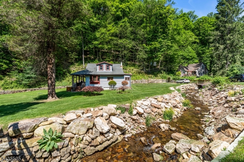 Great Opportunity to Own Your Own Private Country Retreat! Nestled on 2.39 picturesque acres, this charming Cape Cod offers a unique floor plan & an astonishing natural setting. Surrounded by a babbling brook & the beauty of nature, this one-of-a-kind property combines privacy, character, & convenience, all just minutes from shopping, dining, and major roadways.The home features a newer septic system (approx 3 years old), newer electrical panel, pine wood floors, wood stove, & abundant storage throughout. The spacious kitchen offers Corian countertops, a gas stove, & ample cabinetry. The flexible floor plan includes 3 bedrooms, an office, 2 full bathrooms, formal dining area, & a welcoming living room w/ French doors leading to a tiled covered porch. Whether you're looking for a full-time residence or a weekend escape, this property is a wonderful condo alternative w/ room to roam & enjoy the outdoors. Fall asleep to the soothing sounds of the brook, wake up surrounded by nature. Enjoy nearby hiking, biking, fishing, farms, farmers markets, garden centers, pick-your-own berries, restaurants, & endless recreational opportunities.Conveniently located near Routes 78, 57, 31, and 22. Experience all that Warren County has to offer, from its scenic beauty & agricultural heritage to its parks, trails, and proximity to the Delaware Water Gap National Recreation Area. A rare opportunity to enjoy country living at its finest!