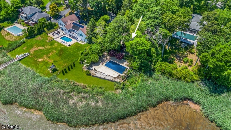 Developers/Builders Dream! Welcome to your private waterfront retreat, where nature, tranquility, and luxury come together in perfect harmony. 1.8 acres nestled along the Manasquan river at the Jersey Shore with 4-bedroom, 3.5-bath, walkout basement residence offers breathtaking views and an unparalleled connection to the outdoors. The heart of the home is the inviting indoor and outdoor living spaces, creating the perfect setting to enjoy peaceful mornings, unforgettable sunsets, and year-round scenic beauty. Whether you're relaxing on the deck overlooking the river, watching local wildlife from your backyard, entertaining in your pool, this property delivers a lifestyle that is truly second to none. Don't miss the opportunity to own this one-of-a-kind riverfront retreat.