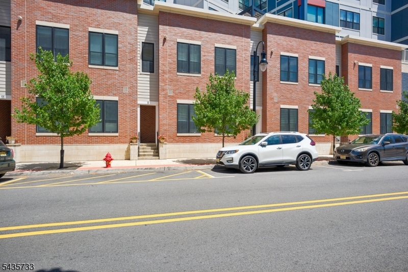 Imagine owning a gorgeous brick townhome with your own front door in the heart of vibrant Bloomfield-- within a one block radius you have access to shops, restaurants, NYC Train Station, Brewery, arcade & more, the ultimate walkable lifestyle can be yours!  Built in 2024 this low-maintenance high style 2-story townhome is bathed in natural light. Over 9 Ft ceilings on the first floor with an effortless flowing floor plan that's great for entertaining. The 1st FL  features a large living room, spacious dining area, a gleaming Chef's Kitchen w/ GE Profile appliances, & a large quartz island. Features include crown moldings, built-in speakers, and a convenient 1st Fl Powder room. Upstairs you'll find the sumptuous Primary Suite with three windows, a customized Walk-in Closet and a luxe ensuite Primary Bath with an oversize Glass Frameless shower and double vanity. The spacious second Bedroom is great flex space and also features a Walk-in Closet. The Full Hall Bath features a tub/shower and stylish tile. Convenient in-unit Laundry room with a GE Profile Washer/Dryer and a large Hall Storage Closet complete the 2nd level. Walk-out your back door to directly access garage parking, amazing building amenities including: Fitness Center/indoor Courts, Co-Work space w/ Conference Room, Pet Spa,Outdoor Movie Area, BBQ Grills, Al Fresco Dining Area, Courtyards w/ Fire Pits, Community Room and so much more! 9 Farrand St offers privacy, proximity, and a plethora of unparalleled amenities!