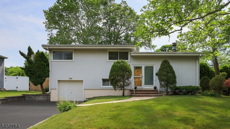 Beautiful Contemporary Split with Cathedral Ceiling, Ideally Located in One of Fanwood's Most Desirable Neighborhoods. Close to NYC Trains & Buses and Within Walking Distance to Schools. Step Into this Bright, Open Floor Plan Featuring a Spacious Living Room with Soaring Ceiling, Floor-to-Ceiling Windows and a Cozy Wood-Burning Fireplace. The Living Room Flows Seamlessly into the Updated Kitchen w/Tall White Cabinetry, SS Appliances and Dining Area, Creating a Wonderful Space for Everyday Living and Entertaining. The Second Floor Features 3 Generous-Sized Bedrooms and a Hallway Full Bath with Tub/Shower. Moving Down to the Ground Level, You Will Find a Comfortable Family Room with Laminate Flooring and a Full Bath with Stall Shower and Access to the Attached Garage. The Partially Finished Basement Offers Flexible Space for a Home Office, Recreation Room or Exercise Area, Along with Laundry and Plenty of Storage. Additional Updates Include Roof(2019) and the Seller is in the Process of Installing a new HWH. Located Just Around the Corner from Brunner Elementary School & SPFHigh School, this Home Offers an Exceptional Combination of Location and Lifestyle. Fanwood, Known as One of New Jersey's Most Beloved Small Towns, Offers Community Events Throughout the Year Including Memorial Day & Halloween Parades, Movies in the Park, 5K Runs, Seasonal Festivals, Excellent Restaurants, a New Library etc. Don't Miss this Opportunity to Own a Wonderful Home in the Heart of Fanwood!