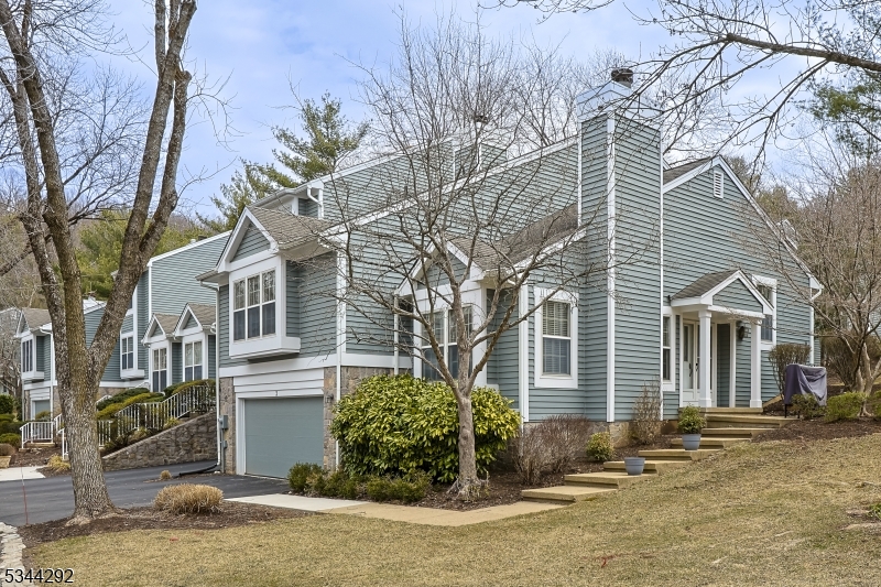 Nestled in the sought-after Hills section of Bedminster, this stunning end-unit condo in the desirable Knollcrest community offers 3 levels of spacious living, featuring 3BED/2.5 BATH. Upon entry, you're welcomed into a sunlit LR with soaring ceilings, elegant architectural details, and intricate moldings. Beautiful HW floors, a WB fireplace, and a charming window bench create a warm and inviting atmosphere.  Level 2 boasts a stylish DR overlooking the LR, setting the stage for intimate gatherings. The pristine white kitchen is a chef's dream, featuring granite countertops, subway tile backsplash, and SS appliances. Adjacent to the kitchen, the FR offers a cozy retreat with a dry bar and sliding doors leading to a private outdoor deck. The primary suite, also located on this level, is a serene sanctuary complete with a custom walk-in closet and a window seat. The spa-like ensuite BATH showcases a double vanity, custom glass-enclosed tile shower, and gleaming hardwood floors.  Level 3 features 2 bedrooms and a full bathroom. The finished lower level offers a spacious recreation area. Additionally, this home includes a 2 car garage and dedicated parking spaces.  Enjoy exceptional amenities, including a trails, gym, tennis courts, clubhouse, a private pool, and 3 additional associations pools.  Conveniently located near The Hills shopping complex with Starbucks, Kings, banks, and local eateries and easy access to major HWY (I-287, 202/206, I-78), parks, golf courses, and more.