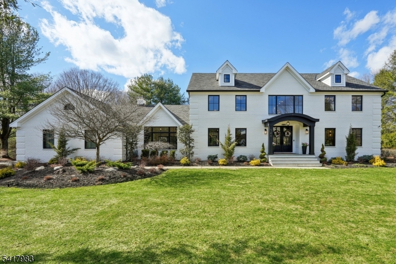 Fully redesigned and rebuilt in January 2025, this custom home offers modern luxury. A two-story foyer, a dramatic family room with a cathedral ceiling and oversized windows bringing in light. Gas or wood burning fireplace creates a warm focal point. Nine-foot ceilings continue on the second level. 5 bedrooms, 5 full baths, office, living room, dining room, and a three-car garage. Porcelain tiles from Porcelanosa highlights the main areas, while European white oak flooring enhances bedrooms and living spaces. A prestigious kitchen by Kuche + Cucina features porcelain countertops by Neolit and a professional-grade appliance suite by Dacor. A first-floor bath includes a custom floating vanity in Himalayan Cristal stone. The primary suite offers a spa-style bath with oversized shower, Victoria + Albert designer soaking tub, custom vanity by Kuche + Cucina, and custom double sinks. Additional bathrooms feature imported European tile and upscale finishes. The finished lower level includes a large open area with tile flooring, playroom, bar with quartzite countertop, full bath, gym, storage, and a custom 8 person sauna. Addition, Spray foam insulation, new septic, tankless water heaters, and an ERV system providing fresh air. Modern trim and upscale finishes. Set on a private 0.92-acre lot surrounded by mature trees. The backyard features a brand-new patio deck, covered lounge, gas fire pit, summer kitchen, rich landscaping, and gated yard.