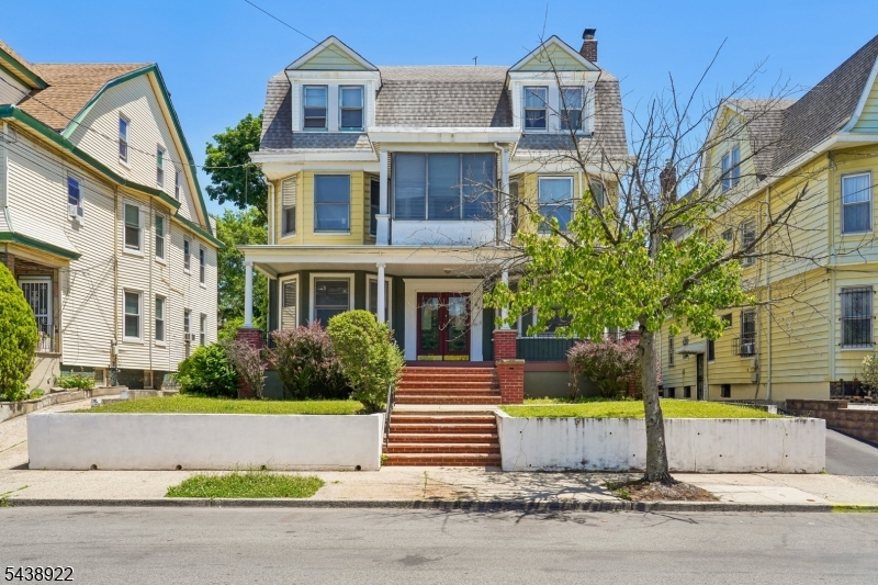 Welcome to this Grand Two-family home filled with timeless character, old-world charm, and generous living space. Lovingly maintained by the same family for decades, this oversized property welcomes you with a spacious front porch and features beautiful stained glass windows, high ceilings, hardwood floors, original woodwork, and architectural Details rarely found today. The first-floor unit offers two bedrooms, one full bath, a spacious living room, formal dining room, and kitchen. The expansive second-floor unit features four bedrooms, two full baths, a kitchen, enclosed porch, and a versatile family room that provides the additional living space today's households are looking for. A stunning interior staircase serves as the centerpiece of the unit, adding warmth and character throughout. While some cosmetic updates may be desired, the home has been well cared for over the years and offers solid bones, exceptional square footage, and endless potential for an Owner-occupant or investor. Whether you're seeking rental income, or a property to make your own, this rare two-family presents a unique opportunity to own a piece of Newark's architectural history. Conveniently located near shopping, schools, major highways, Newark Penn Station, and Newark Airport, with easy access to New York City. Don't miss this rare opportunity to own a truly special home where character, space, and potential come together!