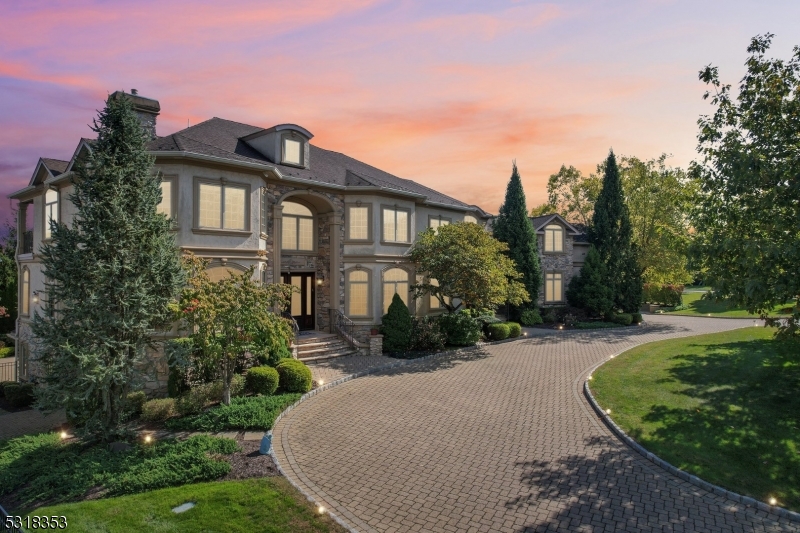 Experience Luxury Living in BEL AIR WOODS! The ONLY ONE on the market, this Stately COLONIAL is set on .57 Acres in Livingston's NEWEST & MOST AFFLUENT neighborhood. Enter into ELEGANT Double-Chandelier Foyer w/ Architectural Digest inspired Staircase. The main level is Entertainer's Dream featuring a FORMAL Living Room with a GAS Fireplace, a sophisticated home OFFICE, and a luxurious Family Room with COFFERED ceilings, flowing seamlessly into a Chef's Dream Eat-In Kitchen w/huge CENTER ISLAND, SS appliances & SLIDER to deck overlooking PRIVATE Swimming Pool. Placed for privacy on the other side of the house, find a Full Bath and Guest Bedroom with a PRIVATE ENTRANCE. 2nd Level hosts Front-to-Back True 900+ sq ft MASTER SUITE with Double-Sided GAS Fireplace, 2 Walk-in Closets, Sitting Room/Office & SPA-Like En-Suite Bath. Additional 4 bedrooms (including a large BONUS Room) + 3 Full Bathrooms. Over 8300+ sq ft of Living Space including FULL FINISHED WALKOUT Basement w/Rec Room w/Kitchen, Exercise Room, Guest Bedroom, Full Bath & tons of storage.  Additional features include 3-car Garage, 2 Laundry Rooms, Basketball Sport Court, Heated Pool and much more. Life is GOOD in LIVINGSTON!
