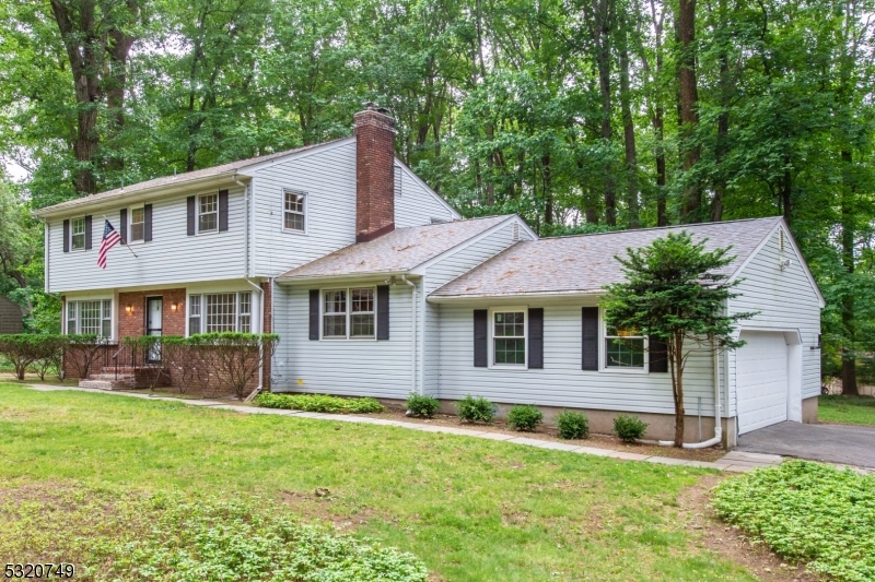 Welcome to this move-in ready, nicely updated center hall colonial on almost an acre of wooded land in the beautiful and quiet neighborhood of Powder Mill Estates. The first floor offers a large and bright living room and a spacious updated eat-in kitchen with newer granite counters, clean kitchen cabinets, and newer stainless refrigerator, dishwasher, stove, and vent. It features a cozy family room and fully renovated powder room with newer washer/dryer. Newer tile, vinyl, and refinished oak floor throughout. The living room and family room lead outdoors where you can relax on the stone patio in a peaceful setting. The second floor offers a primary bedroom suite with updated bathroom and a large closet. 3 additional spacious bedrooms with oak flooring and generous closets. A full, updated bath completes this floor. The partially finished basement is perfect for a rec room and there's a bonus workshop. Cool and shady in summer and bright and sunny in winter, this home is in a great location, convenient to Routes 10, 287, and 80, shopping, parks, NJ Transit with direct service to NYC, and highly rated schools. Tenant pays first $100 of each repair, must obtain tenant's insurance. NTN application with strong credit, income verification required.