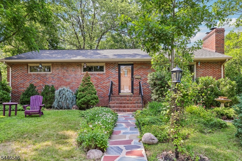 A charming Fairwoods gem offered for the first time in more than 30 years! Lovingly maintained and thoughtfully updated, this inviting Ranch combines the convenience of an exceptional location with the serenity of a park-like setting. Step into a spacious living room filled with natural light from the oversized casement window and anchored by a stunning floor-to-ceiling brick fireplace. The thoughtfully designed floor plan flows seamlessly into the dining room and beautifully renovated kitchen with white oak hardwood floors extending throughout the main living spaces. The kitchen features a large center island with granite and butcher block countertops, stainless steel appliances, and abundant maple cabinetry for exceptional storage. Just beyond the kitchen, step outside to a slate patio overlooking the lushly landscaped backyard with easy access to the detached two-car garage. The primary suite offers two closets and en-suite access to the hall bathroom. Two additional bedrooms, each with recessed lighting and privacy windows complete the main level. The lower level features a spacious recreation room, two flexible rooms with built-in bookcases that are ideal for home offices, the second full bathroom, a separate laundry room, workshop, and a storage/utility room. Ideally situated just over a mile from downtown Madison and direct NYC train service, and only moments from Loantaka Reservation.