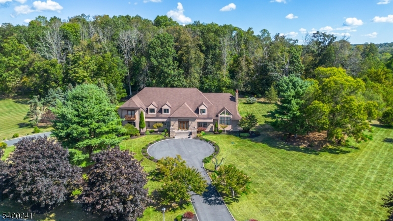 Welcome to this magnificent 6-bedroom, 5.5-bathroom home located in the desirable Hendel Estates of Green Township, NJ. Thoughtfully designed and beautifully appointed, this residence offers exceptional space, style, and comfort. The main level features hardwood flooring, a spacious open layout, and a stunning floor-to-ceiling stone fireplace that anchors the living area. The gourmet kitchen features granite countertops, a stylish backsplash, a large center island, and French doors leading to the patio, perfect for seamless indoor-outdoor living. A convenient first-floor guest room with a full private bathroom provides flexible accommodations for visitors. Upstairs, you'll find spacious bedrooms, including a luxurious primary suite boasting two walk-in closets, a sitting area, and a large bathroom with a sunken tub. An additional finished attic room is ideal for a home office, studio, or recreation area. The expansive finished basement extends the living space even further, offering a wet bar, a dedicated office, and ample room for entertainment, hobbies, or relaxation. This extraordinary home combines elegance, warmth, and modern amenities, delivering the perfect blend of luxury and comfort in Green Township. See floor plan for room dimensions. The property is conveniently located for commuting to Routes 80 and 206, as well as shopping. Look at the floor plan.